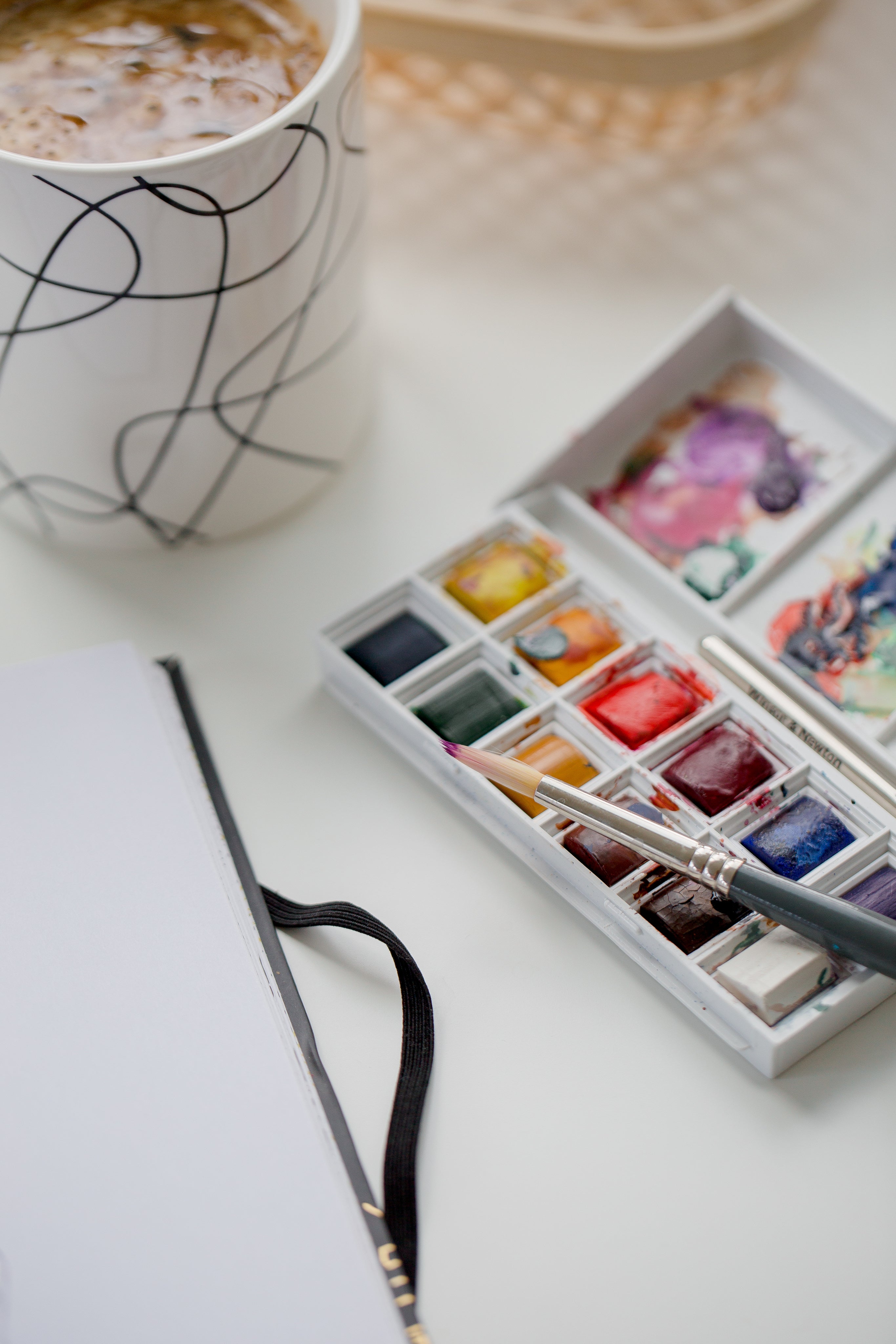 watercolor-paint-pallet-and-mug-of-hot-chocolate.jpg